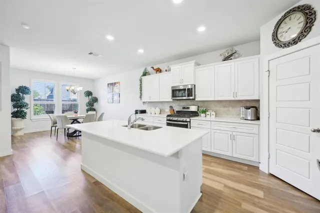 a kitchen with white cabinets and white appliances