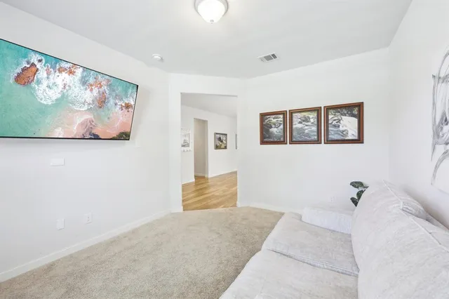 a bedroom with a bed and wall painting