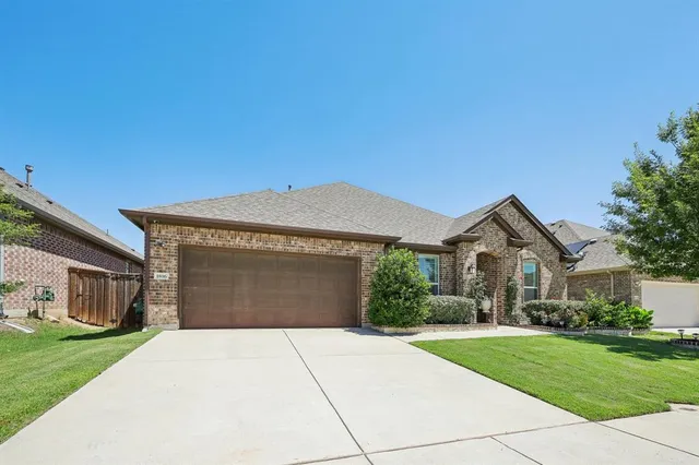 a front view of a house with a yard and a garage