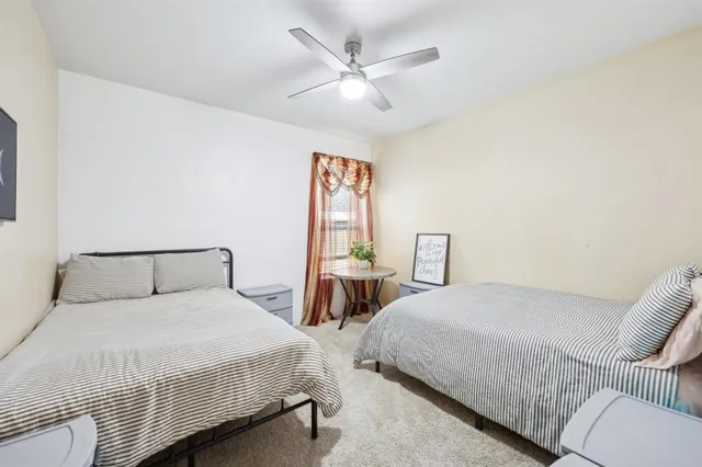 a bedroom with two beds and a chandelier