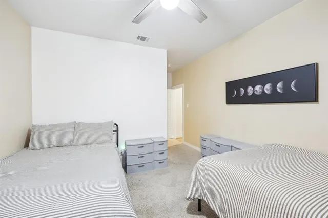 a bedroom with a bed and a night stand