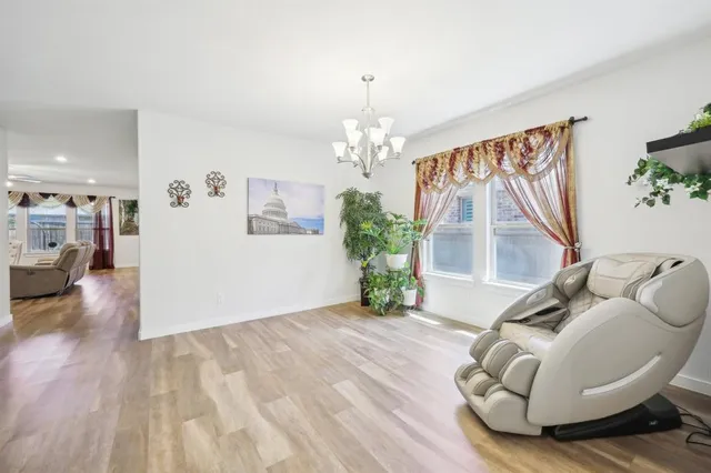 a living room with furniture and a chandelier