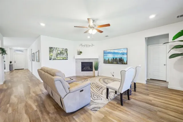 a living room with furniture and a wooden floor