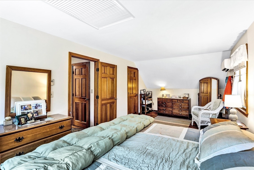 1 Carver Road Brewster, MA 02631 - Photo 11 of 33 a bedroom with furniture and a large window