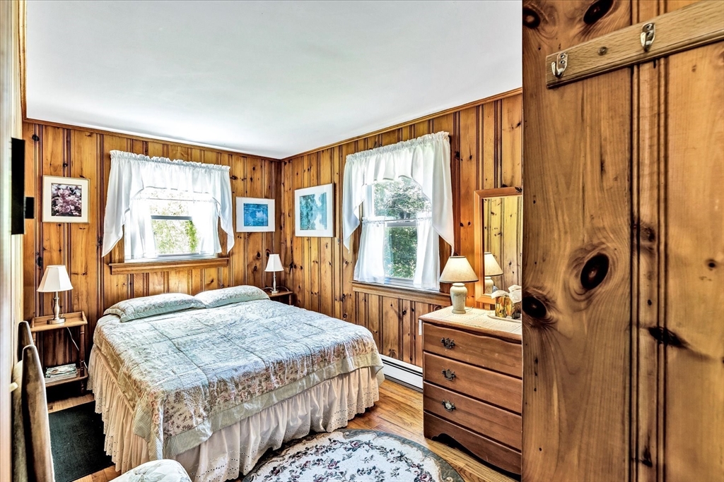 1 Carver Road Brewster, MA 02631 - Photo 16 of 33 a bedroom with a bed and a dresser next to a window