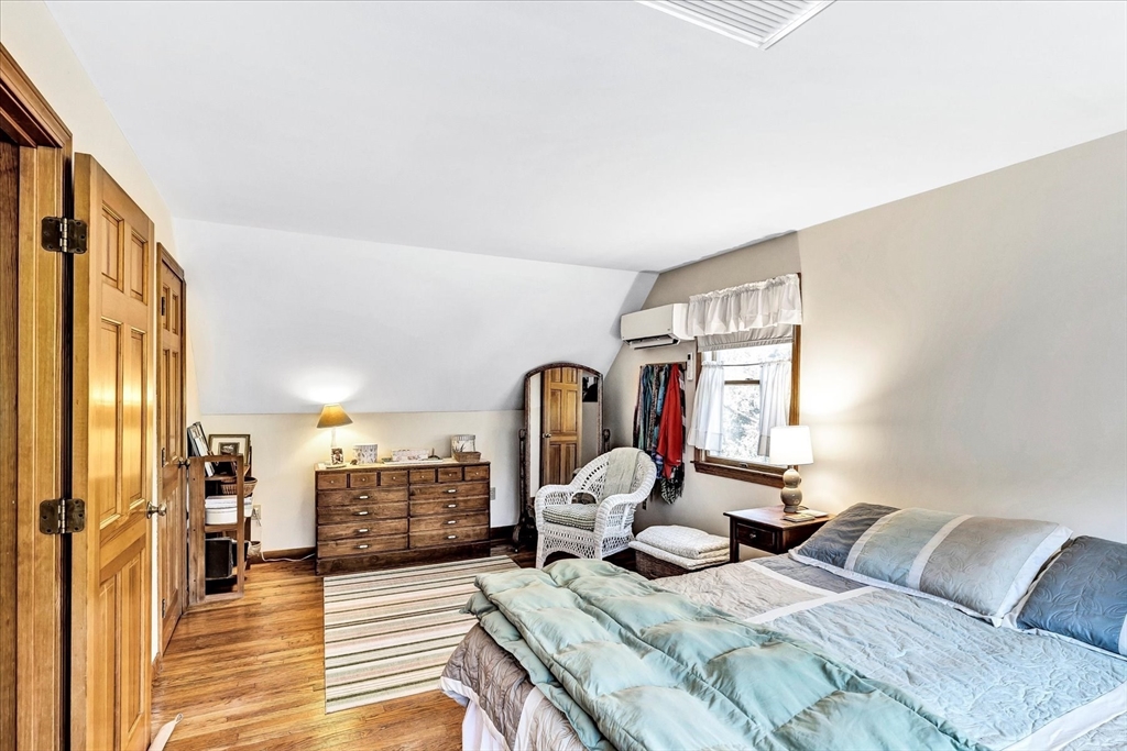 1 Carver Road Brewster, MA 02631 - Photo 10 of 33 a bedroom with a bed and wooden floor