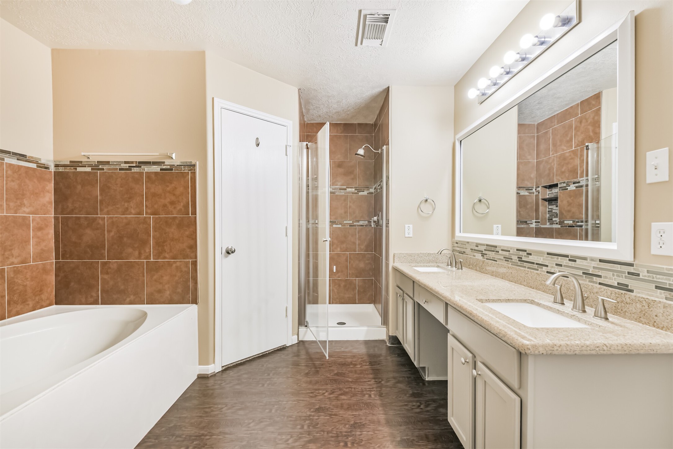 2415 Fox River Lane Spring, TX 77386 - Photo 19 of 34 a bathroom with a granite countertop tub sink a shower and a mirror
