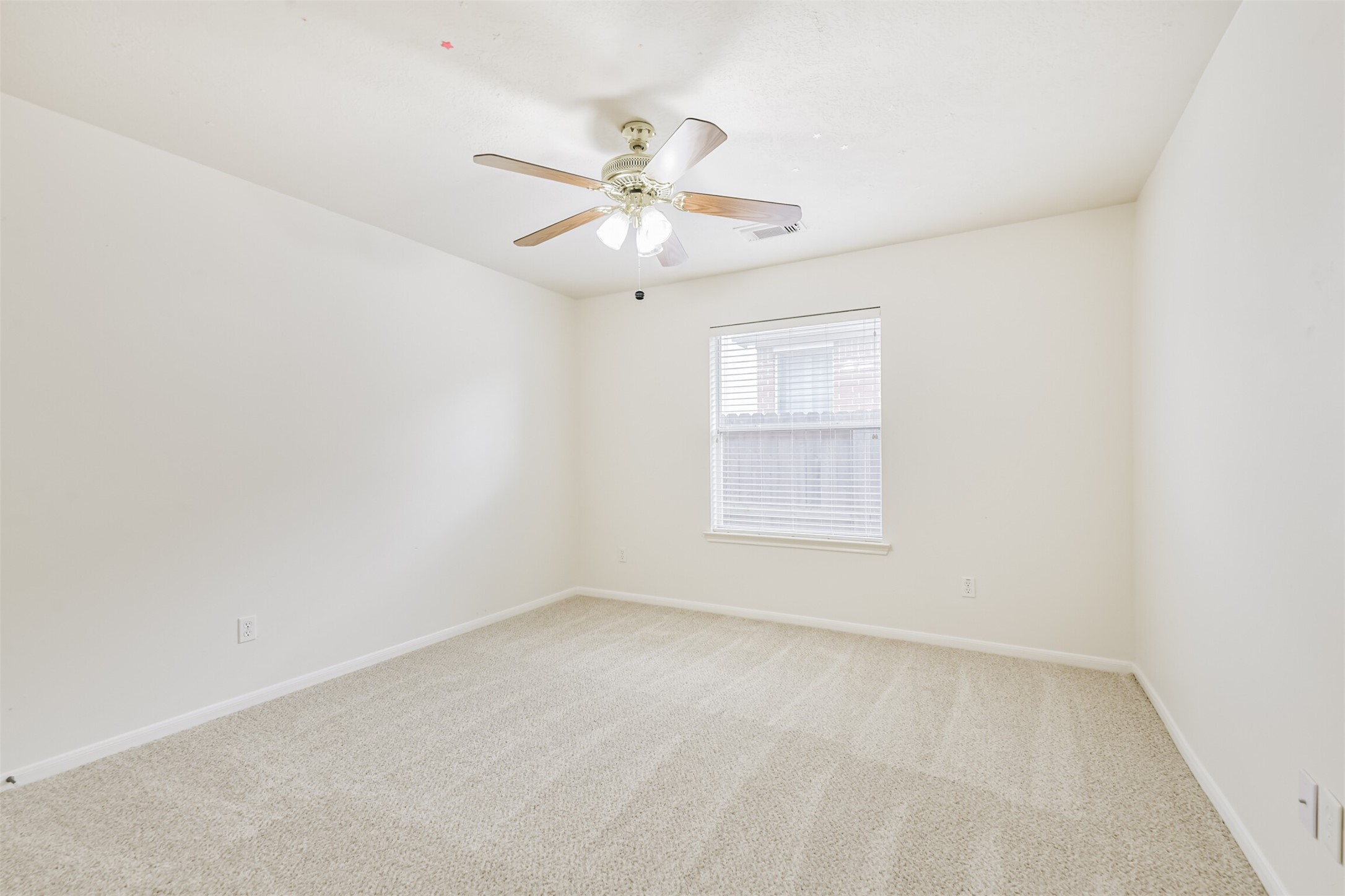 2415 Fox River Lane Spring, TX 77386 - Photo 27 of 34 an empty room with a window and ceiling fan
