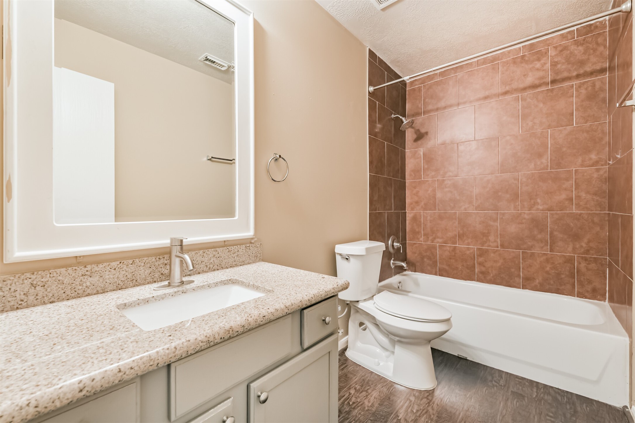 2415 Fox River Lane Spring, TX 77386 - Photo 29 of 34 a bathroom with a granite countertop sink a toilet and shower
