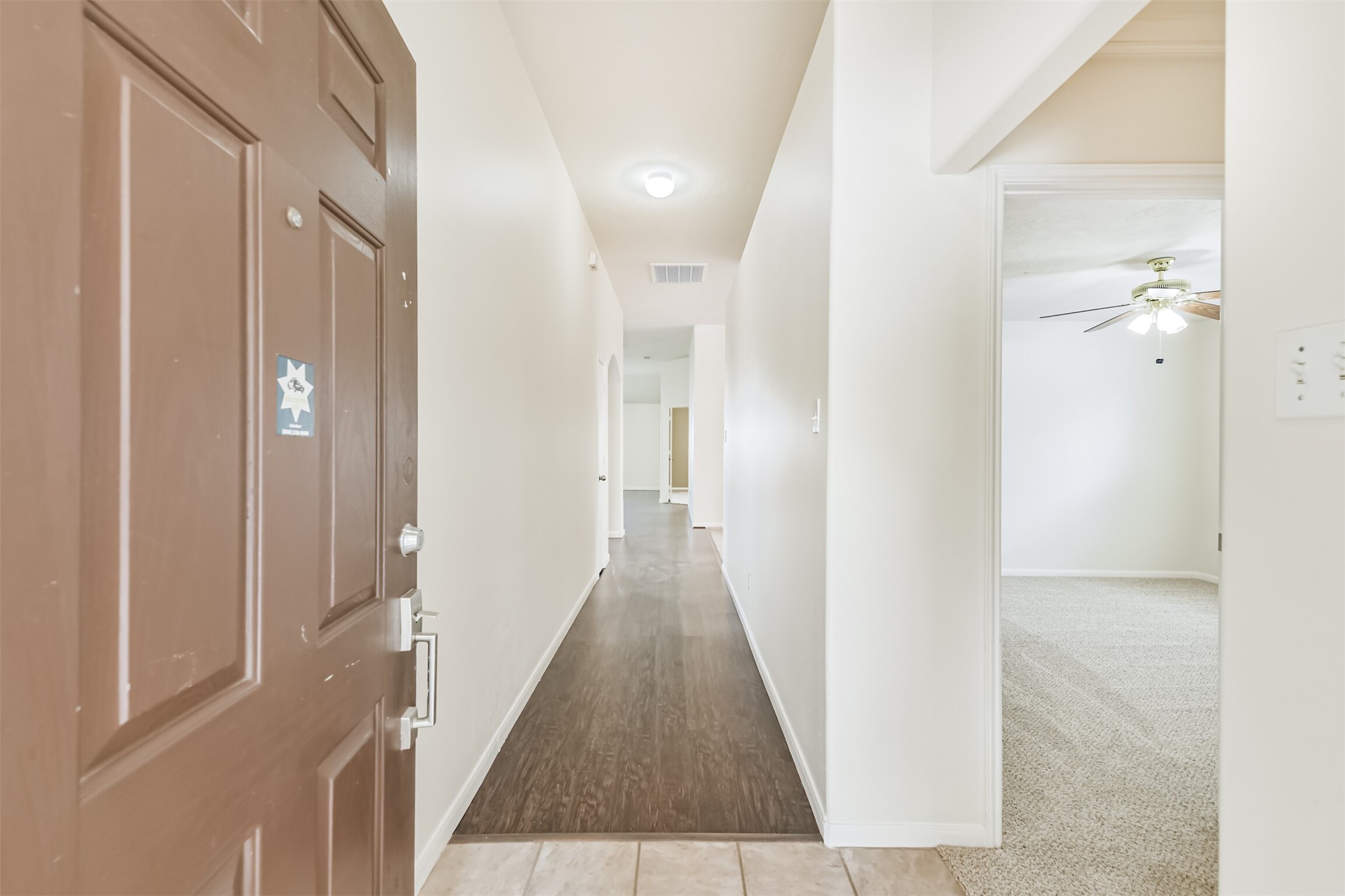 2415 Fox River Lane Spring, TX 77386 - Photo 4 of 34 a view of a hallway with wooden floor and a bathroom