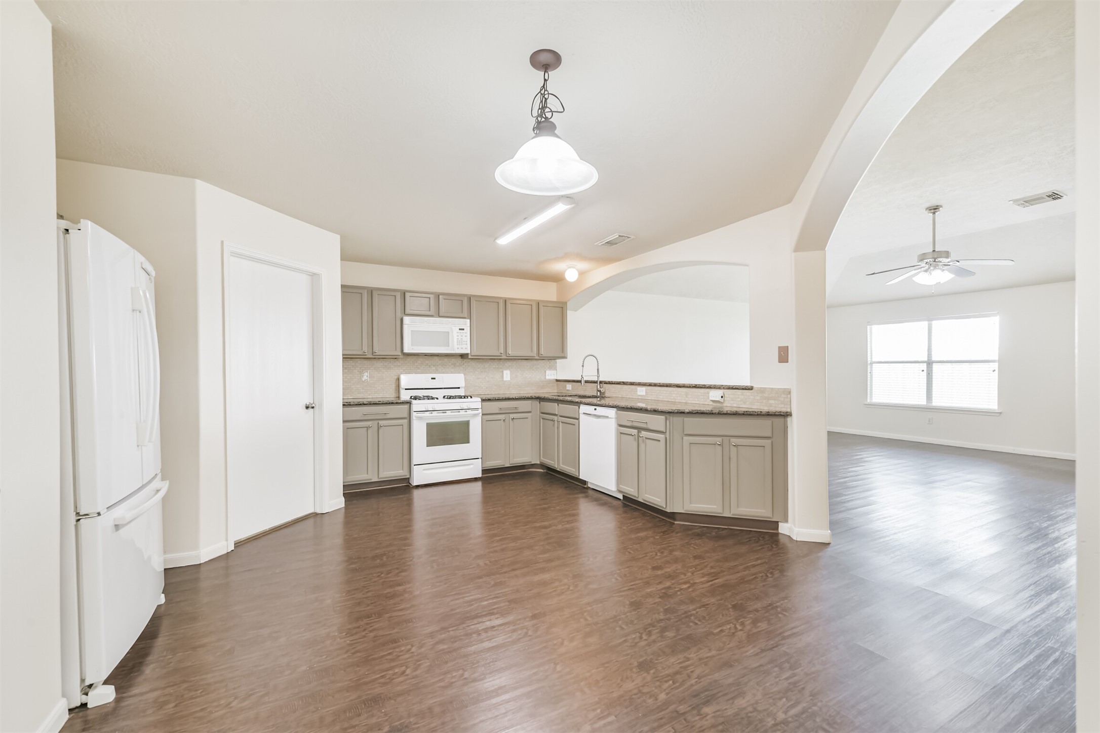2415 Fox River Lane Spring, TX 77386 - Photo 6 of 34 a view of a kitchen center island wooden floor and stainless steel appliances