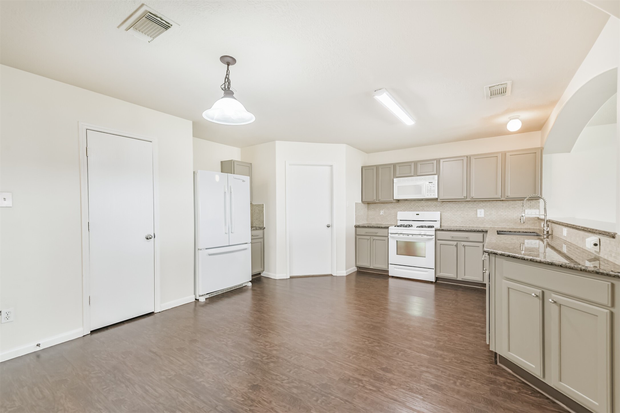 2415 Fox River Lane Spring, TX 77386 - Photo 7 of 34 a kitchen with a white cabinets and stainless steel appliances