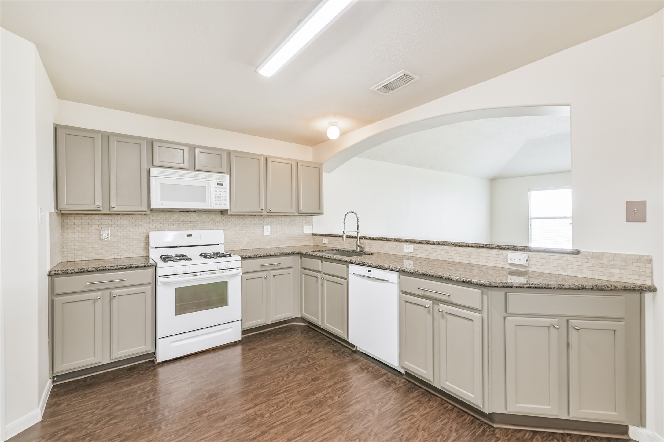 2415 Fox River Lane Spring, TX 77386 - Photo 8 of 34 a kitchen with granite countertop white cabinets and white appliances