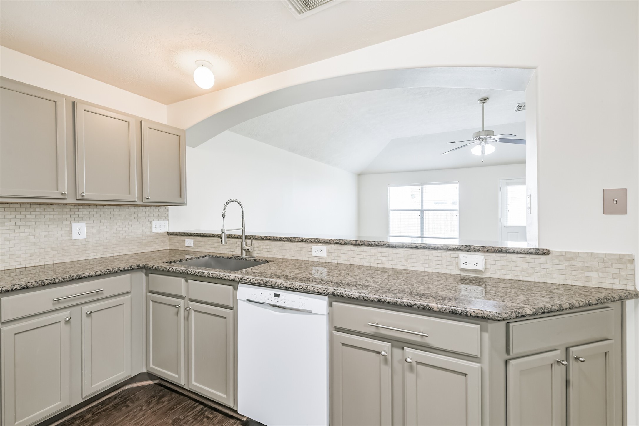 2415 Fox River Lane Spring, TX 77386 - Photo 10 of 34 a kitchen with sink granite and white cabinets