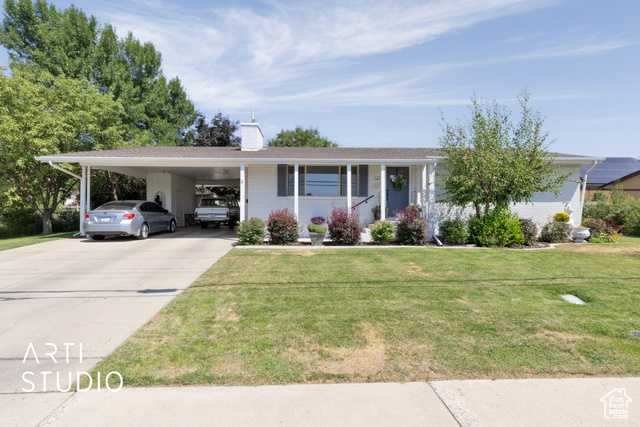 847 East 400 South Orem, UT 84097 - Photo 1 of 1 Ranch-style home with brick siding, concrete driveway, a chimney, an attached carport, and a front yard
