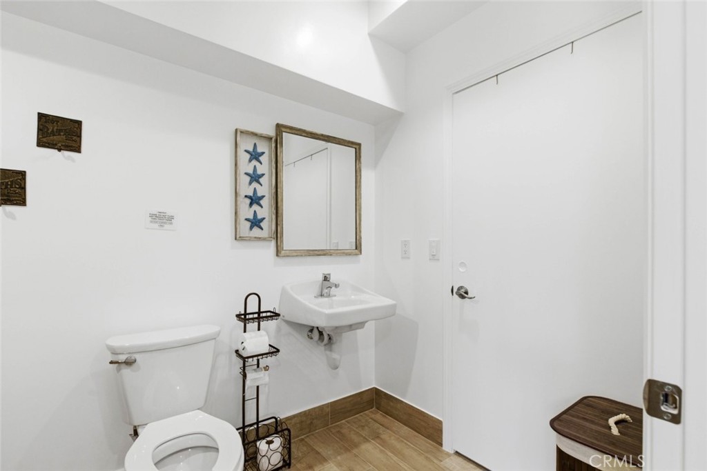 301 West Ashby Street Azusa, CA 91702 - Photo 69 of 75 a bathroom with a sink a toilet and mirror