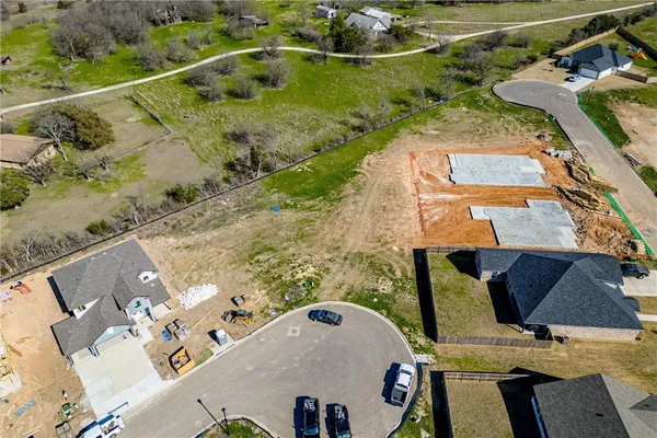 an aerial view of a house with a yard
