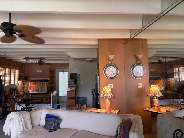 a living room with furniture and a clock