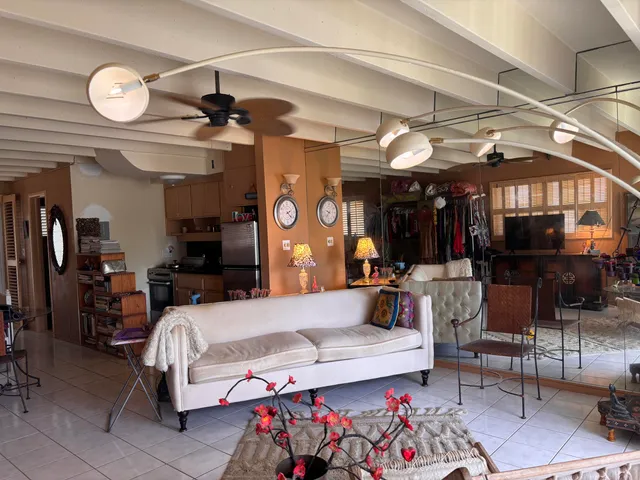 a living room with lots of furniture and a chandelier