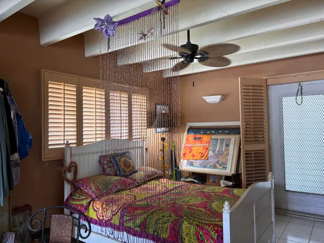 a bedroom with bed and window