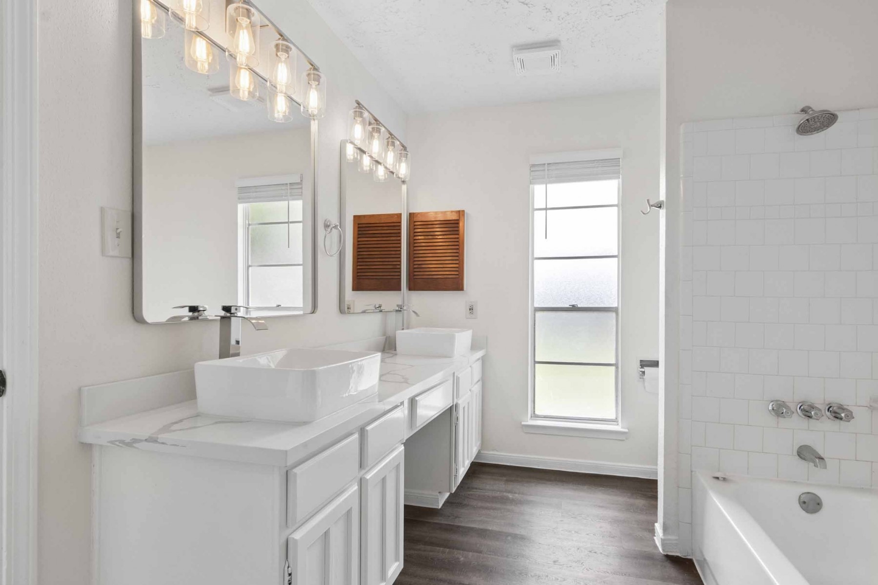 10411 Rabbit Oak Drive Houston, TX 77065 - Photo 17 of 22 The primary bathroom features a modern double vanity with vessel sinks, large mirrors, and stylish lighting.