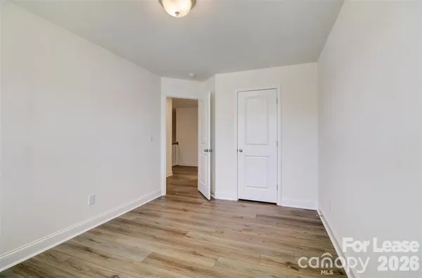 a view of an empty room and wooden floor