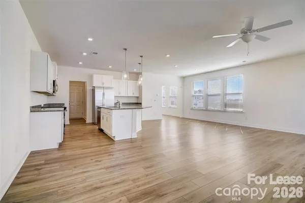 a view of kitchen with refrigerator and window