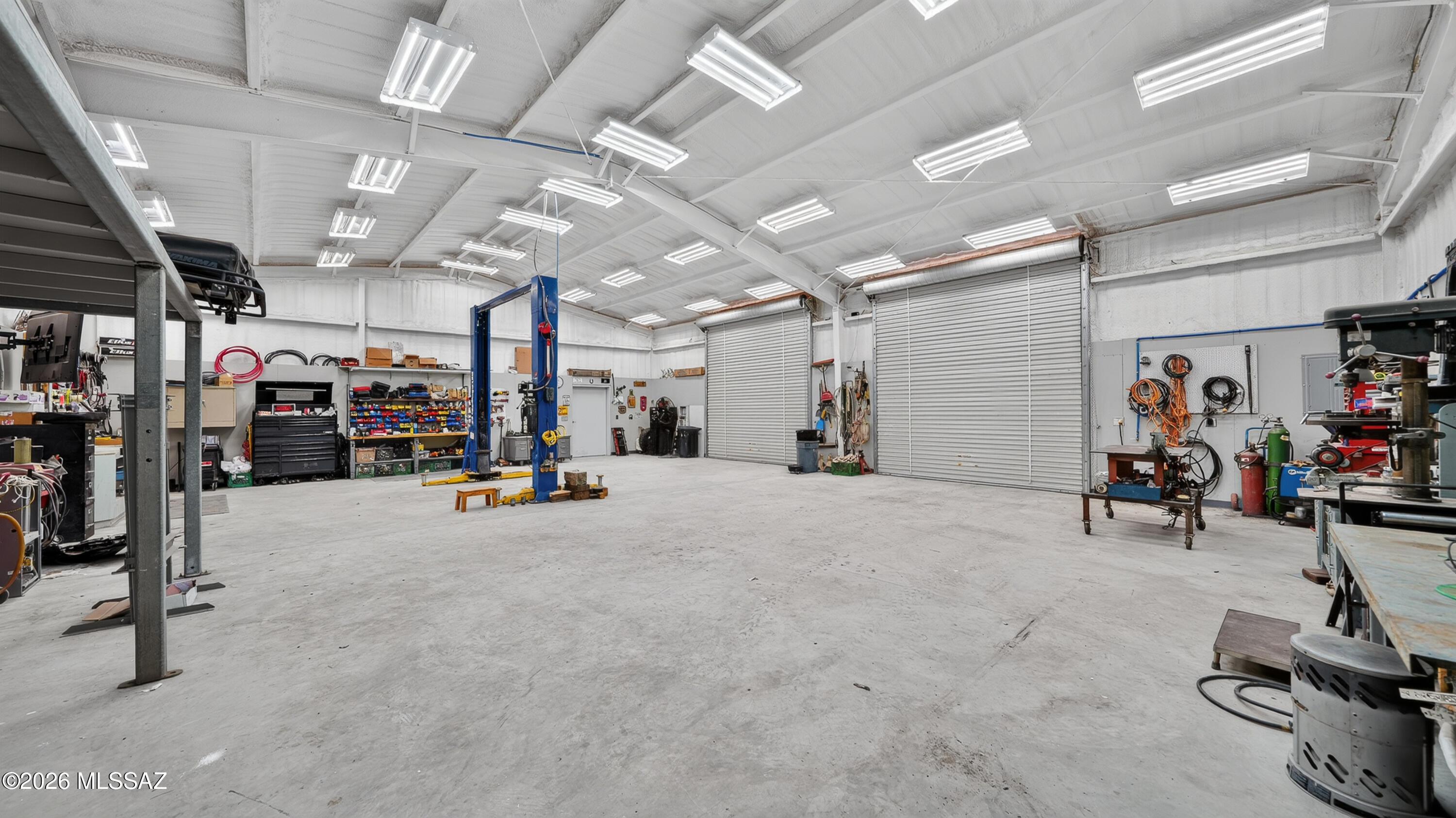 194 Taylor Road Willcox, AZ 85643 - Photo 39 of 54 50x40 (16' tall at peak), 2- 4' foot Steel Entry Doors, 6" Concrete Slab, 2- 12x12 Roll up doors, Spray foam insulated, 3/4" tongue grove sheeting (8' tall) 200 amp with multiple 110 & 220 outlets, 30 LED Shop lights, Plumbed on demand Air with 60 gallon Air Compressor