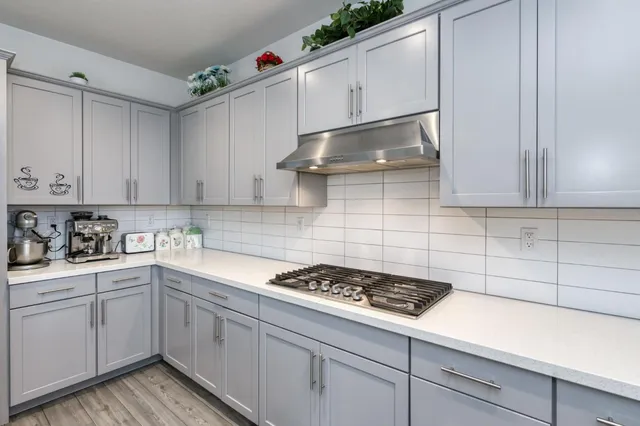 a bedroom with a bed and a flat tv screen on dresser