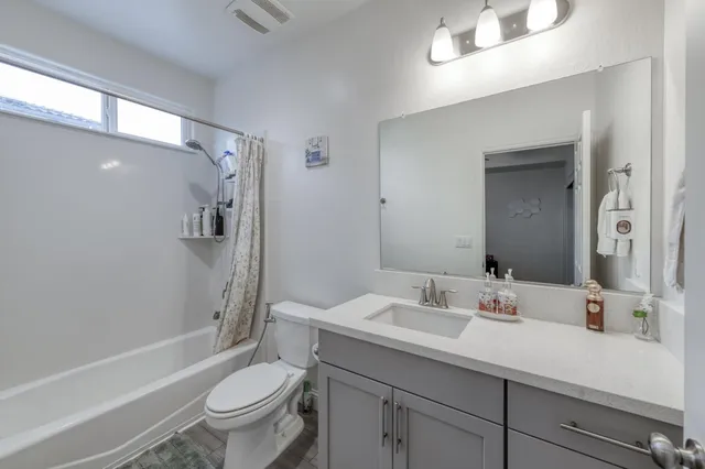 a bedroom with furniture and a window