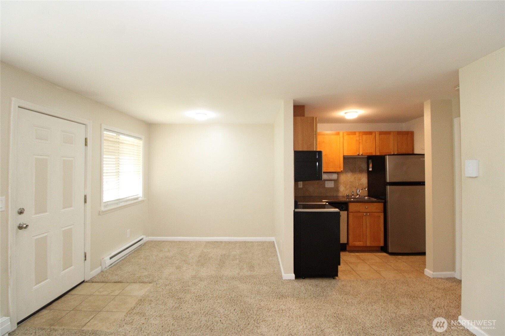 604 North 3rd Street, Unit 7 Tacoma, WA 98403 - Photo 3 of 12 a view of a kitchen with a stove cabinets and a refrigerator