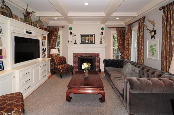 23 Suffolk Road Wellesley, MA 02481 - Photo 4 of 26 a living room with furniture a flat screen tv and a fireplace