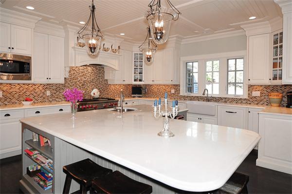 23 Suffolk Road Wellesley, MA 02481 - Photo 8 of 26 a large kitchen with kitchen island a stove a sink a dining table and chairs
