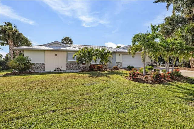 a view of a house with yard and sitting area
