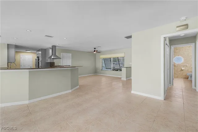 a view of a kitchen with a sink and a refrigerator