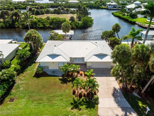 an aerial view of a house with garden space and lake view