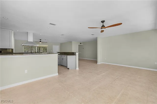 a view of a kitchen with a sink and a refrigerator