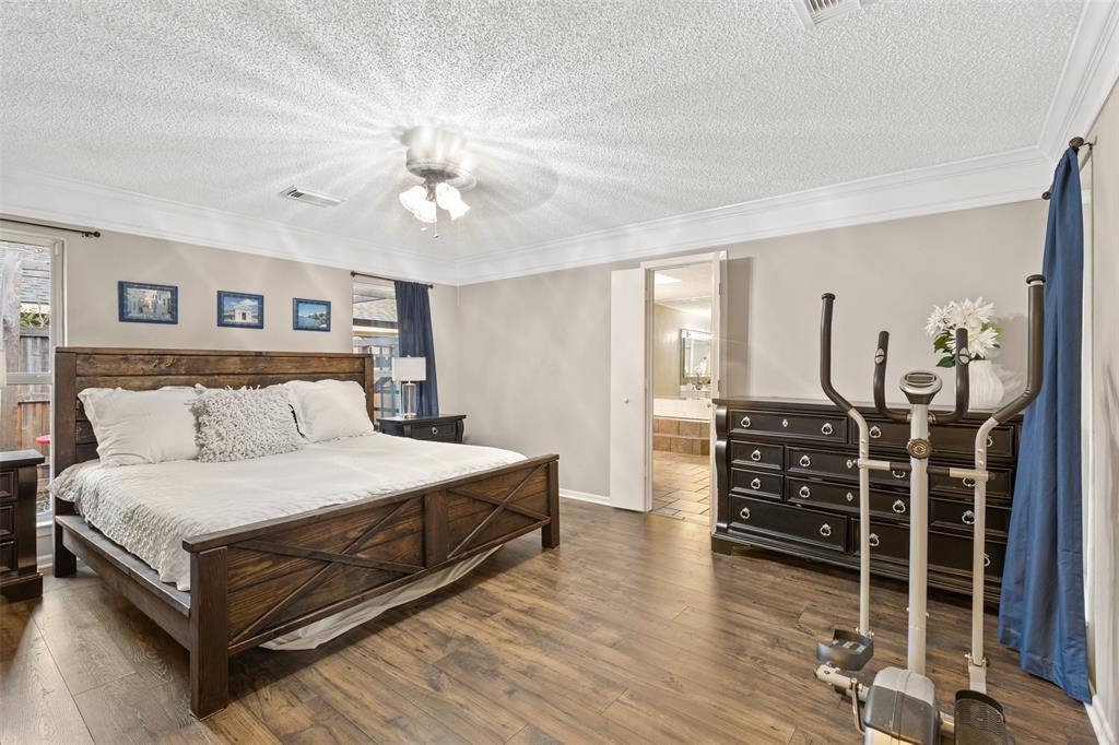 1105 East Spring Valley Road Richardson, TX 75081 - Photo 13 of 40 Bedroom with visible vents, ornamental molding, and wood finished floors