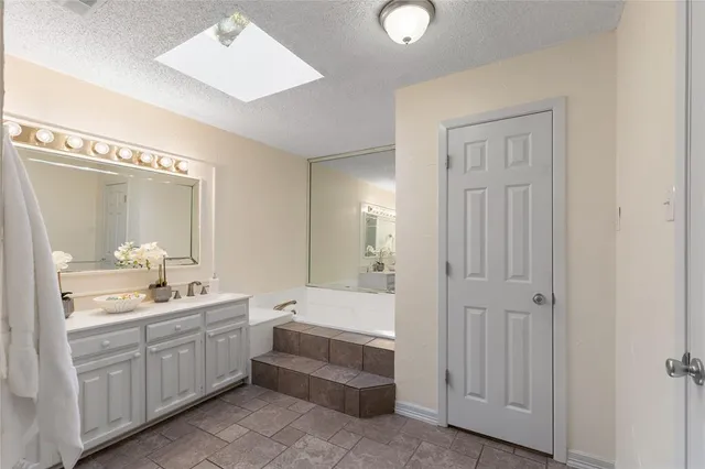 a bathroom with a double vanity sink and mirror with shower
