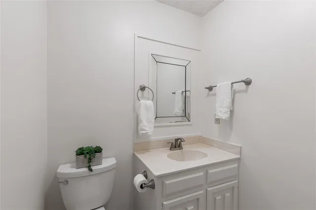 a bathroom with a sink toilet and a mirror