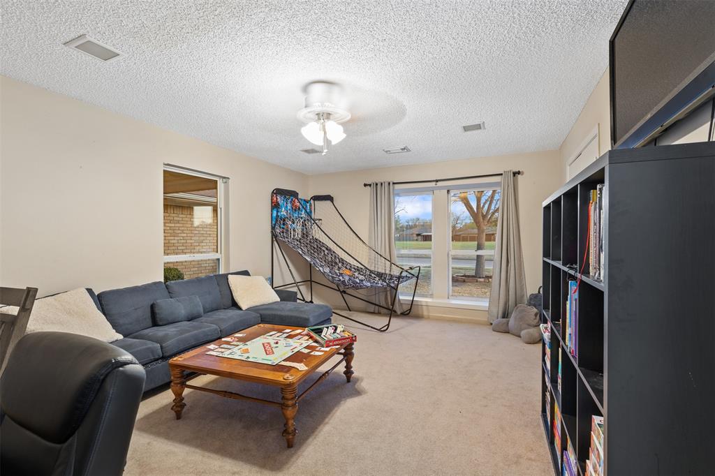 1105 East Spring Valley Road Richardson, TX 75081 - Photo 23 of 40 Game room featuring a textured ceiling, light colored carpet, and ceiling fan