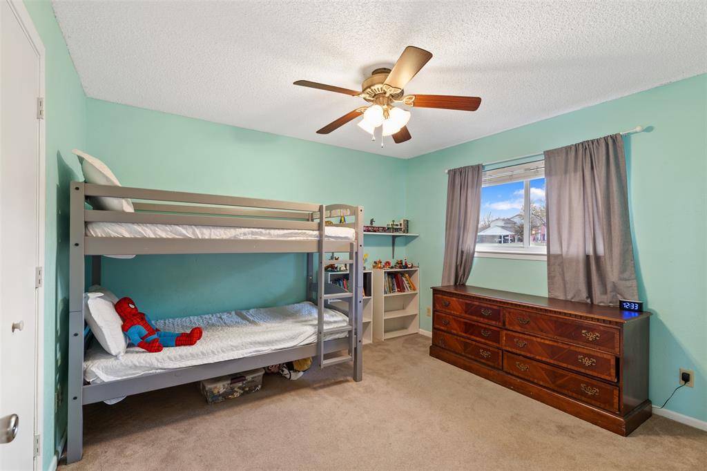 1105 East Spring Valley Road Richardson, TX 75081 - Photo 25 of 40 Carpeted bedroom featuring baseboards, a ceiling fan, and a textured ceiling