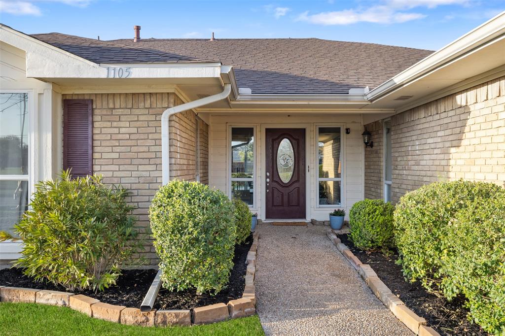 1105 East Spring Valley Road Richardson, TX 75081 - Photo 29 of 40 Property entrance with brick siding and roof with shingles