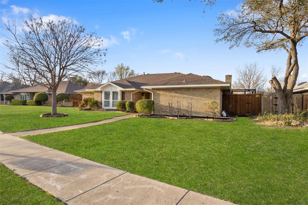 1105 East Spring Valley Road Richardson, TX 75081 - Photo 33 of 40 Ranch-style house featuring fence, a chimney, brick siding, a front lawn, and a shingled roof