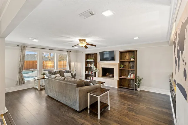 a living room with fireplace furniture and a wooden floor