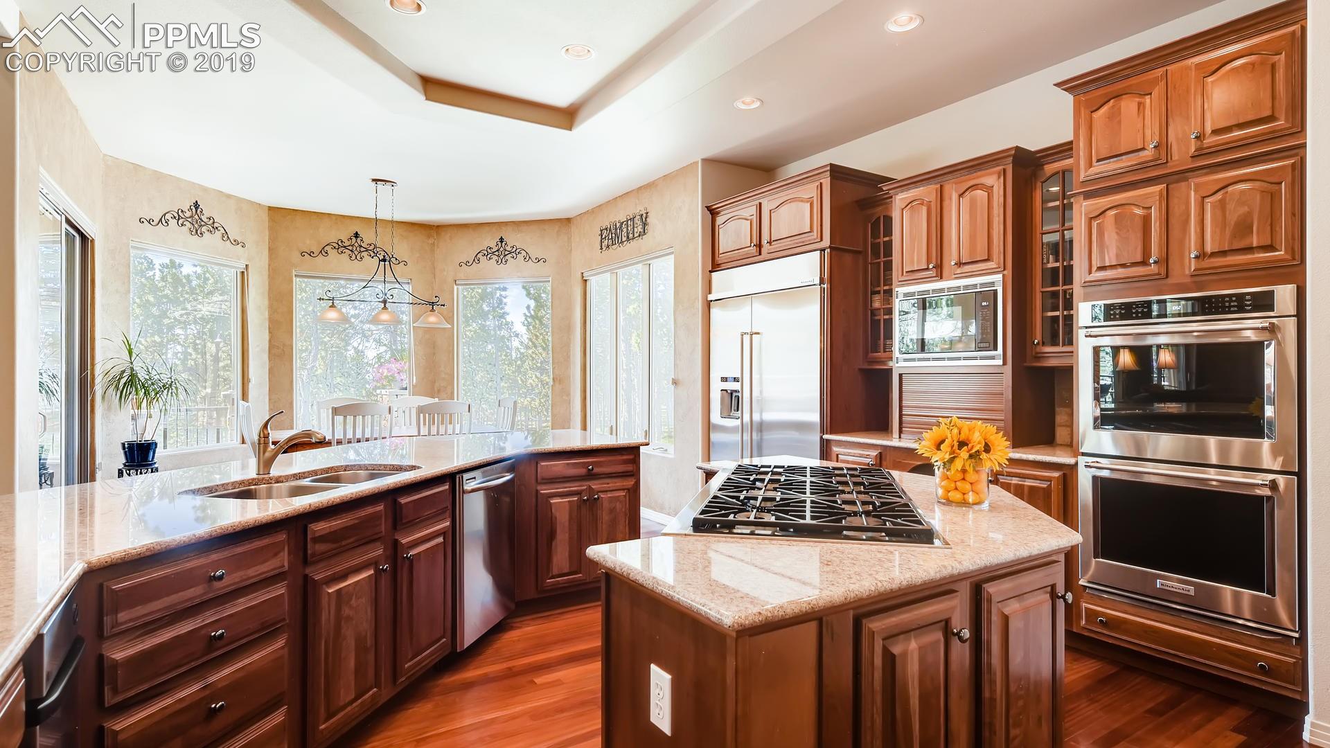4061 High Forest Road Colorado Springs, CO 80908 - Photo 9 of 40 Gourmet kitchen with 6-burner Dacor gas stove, double ovens, cherry wood cabinetry...