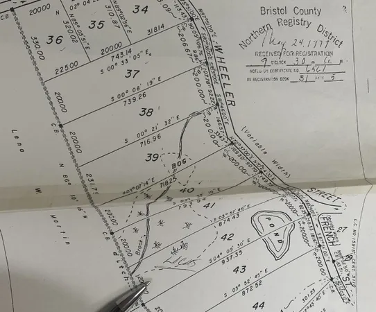 a view of a bed with a white comforter