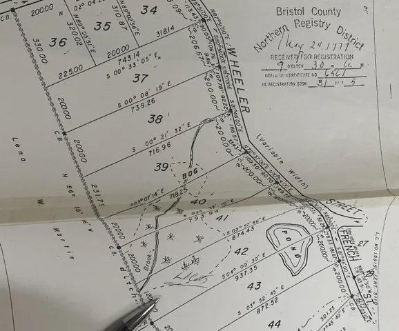 a view of a bed with a white comforter