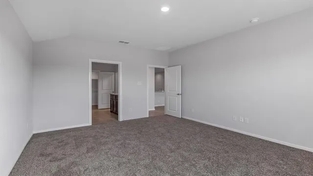 a bathroom with a granite countertop sink and a bathtub