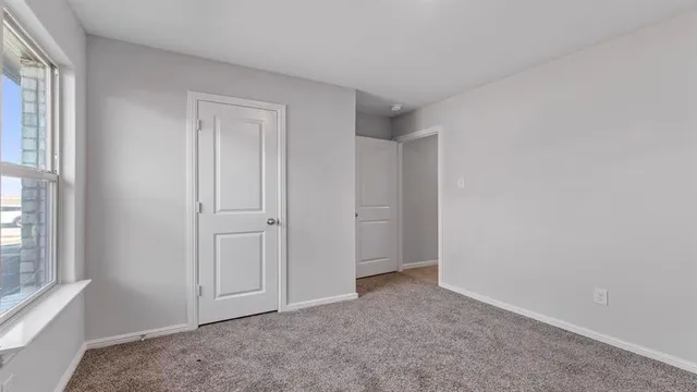 a view of an empty room and a window